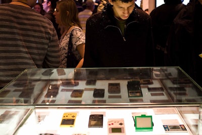 Game cartridges from old Nintendo systems sat in glass display cases, while guests played various incarnations of Mario on the new Wii system.