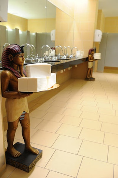 Egyptian statues held hand towels inside the restrooms.