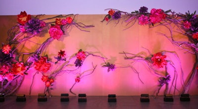 The step-and-repeat in the museum lobby featured the same oversize flowers used in the pop-up garden at the cocktail hour.