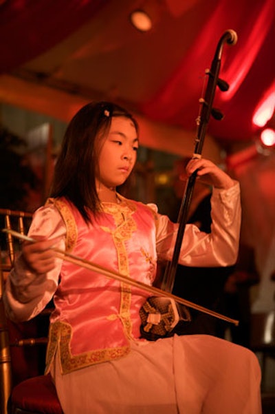 The Asian Community Service Center also supplied 11-year-old Linda Wang to play the erhu, an ancient two-string instrument.