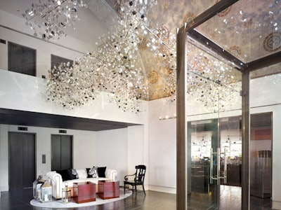 The lobby of the Ames houses 'Mirror Cloud ', a fragmented chandelier created for the hotel by London based artists Sophie Nielsen and Rolf Knudsen of Studio Roso.