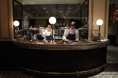 A French pewter bar, mosaic floors, antique light fixtures, and a mural by French artist Paulin Paris deck the space.