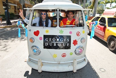A Volkswagen bus decorated with peace sign and flower stickers lead a procession of motorcycles down Washington Avenue to promote the wine's arrival at the restaurant.
