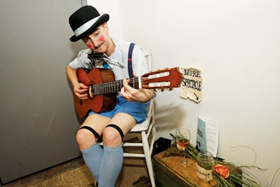 At Redmoon Theater's Spectacle Lunatique benefit in Chicago, a rosy-cheeked guitarist serenaded guests in line for the restroom.