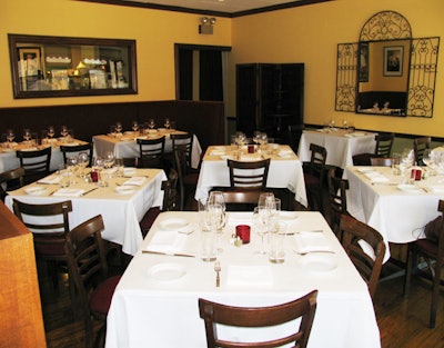 The north dining room seats 50 and looks into the kitchen through a glass window.