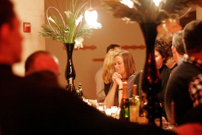 Flower arrangements in tall black vases also topped the main bar.