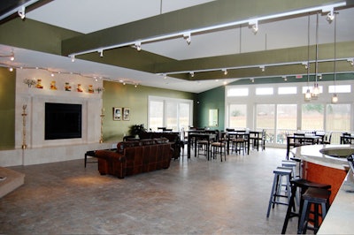The focal point of the tasting room is a massive white marble fireplace.