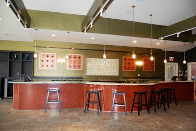 The tasting room's 30-foot bar top is a thick epoxy surface inlaid with peacock feathers and gold glitter.