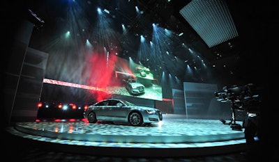 For the car's official debut, the walls behind the stage opened and an Audi executive drove the vehicle onto the main stage of the performance area.