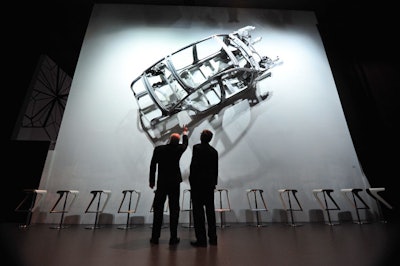 An Audi car frame hangs in the hallway between the pavilion's arena and exhibition spaces.