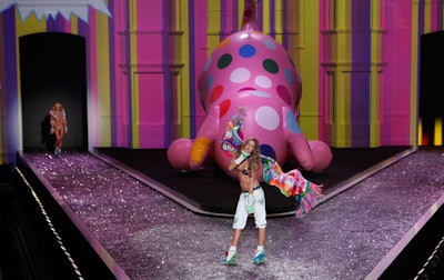 The building facade used as the background for the stage opened throughout the show, for large set pieces and props like an inflatable dog.