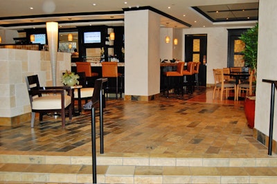 The restaurant entrance has slate floors and low limestone walls, which separate the bar and lounge area.