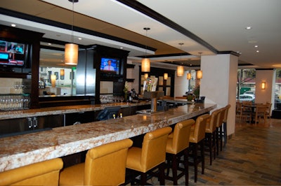 The L-shaped bar has a granite top and comfortable high-backed seats.