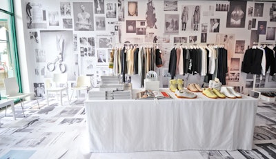 Black-and-white fashion images cover the walls and floor in Maison Martin Margiela's space. The company also displayed a few of its hand-made pieces, including a dress made from cut and warped vinyl records.