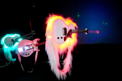Gibson Guitars provided custom-made instruments, which tech designer Moritz Waldemeyer outfitted with lasers on the ends for band OK Go's nightly performances.