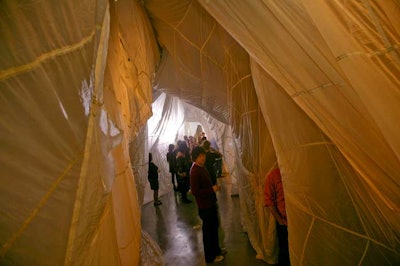 On Tuesday night, artist Jordan Doner debuted his interactive art installation 'Land ' at the 101/Exhibit space in the design district. Guests arrived through a hallway of billowing parachute silk upon which Haley Mellin projected videos from other participating artists such as Doug Aiken and Bruce Nauman.
