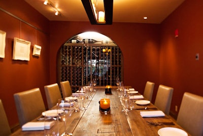 The 16-seat private dining room overlooks the Public Garden and has a window peering into the restaurant's wine collection. Barn doors enclose the space.