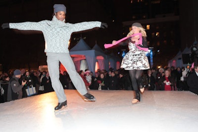 A pair of professional skaters twirled around on an elevated skating rink at the center of the plaza.