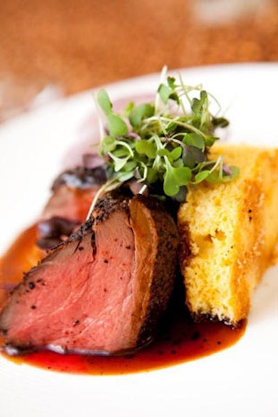 Coffee-rubbed filet of beef, sauteed spinach, grilled red onions, and corn bread served as the main course.