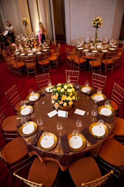 Table centerpieces alternated between low and high rose topiary arrangements.
