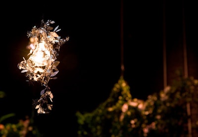 An ode to a Chinese lantern in the play's set, metallic lace covered bare bulbs.