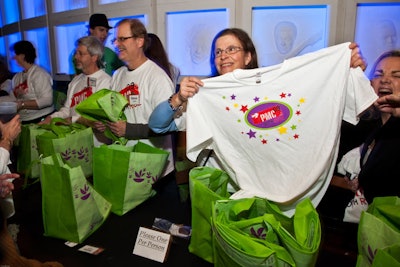 Volunteers handed out reusable Stop & Shop bags with Pan Mass Challenge T-shirts inside to departing partygoers.
