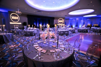 J Group used blue uplighting and candles on all the dinner tables to illuminate the ballroom for the Miami Art Museum Ball.