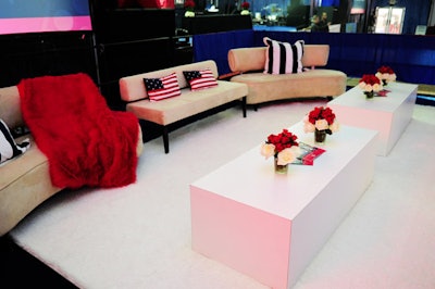 The Events Company outfitted the V.I.P. lounge with tan suede sofas, white coffee tables, and striped and American flag pillows.