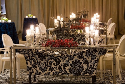 Cranberries, candles, and reindeer sculptures topped tables in the reception area.