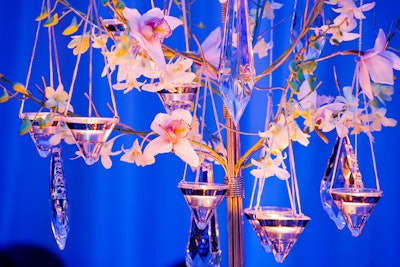 Centrepieces included white orchids, crystal ornaments, and tealight candles.