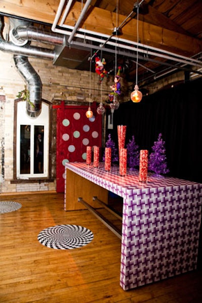 Purple Christmas trees and vases filled with jelly beans and hot pink popcorn topped a table in the hallway, where peel-and-stick circles created an op art display on the floor.