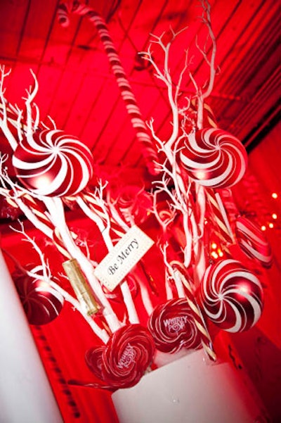 Tall white trees surrounded by, and decorated with, candy canes, candy apples, and gingerbread men filled the red and white enchanted forest, inspired by 'Hansel and Gretel.'