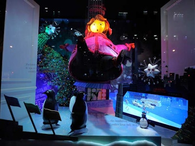 Above the window displays at Saks Fifth Avenue, which uses velvet ropes to control the gawkers, the facade of the building is covered with illuminated snowflakes that pulse to 'The Carol of the Bells' when it's dark outside.