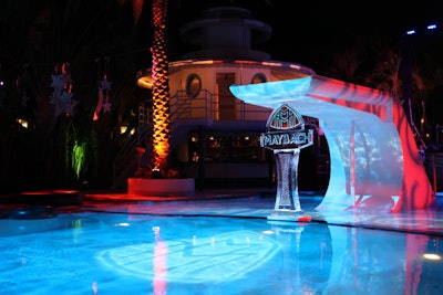 An ice sculpture of the Maybach logo, which LaChapelle later pushed into the pool, sat under the diving board.