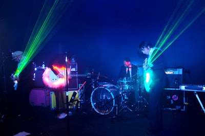 The band OK Go performed nightly with custom-made Gibson guitars, which tech designer Moritz Waldemeyer outfitted with lasers on the ends, in Design Miami's sprawling space.