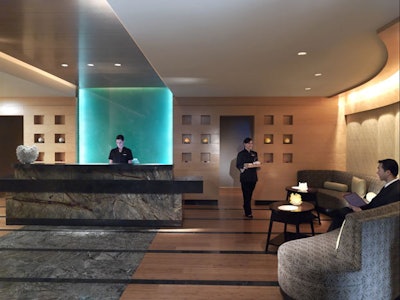 Bamboo flooring and a water feature accent the spa's concierge area.