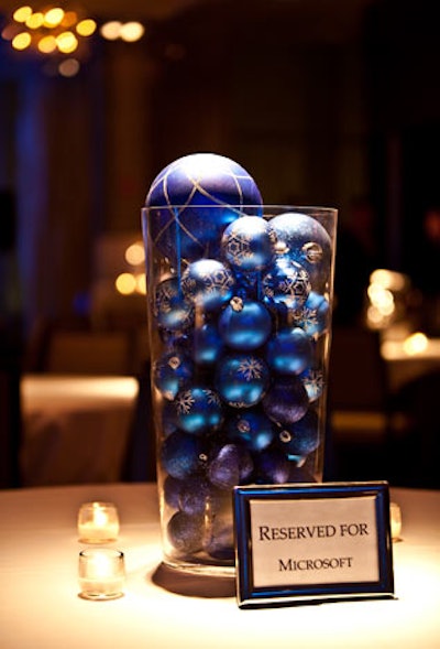 Glass vases filled with on-theme ornaments served as centerpieces.