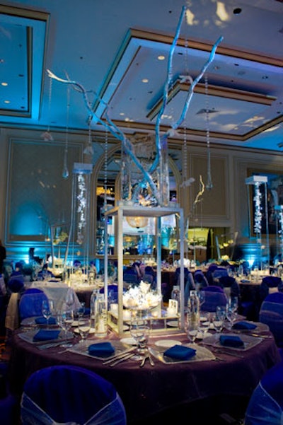 Kehoe designed three different centerpieces for the dinner room; one arrangement incorporated dragon wood branches.