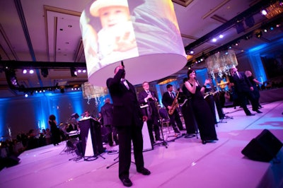 Photos of patients also appeared in a lamp shade that hung over the stage where the Ken Arlen Orchestra performed after dinner.