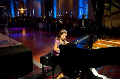 Eight-year-old pianist Emily Bear, who began performing at Ravinia at age 5, played after dinner and received a standing ovation.