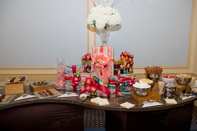 Decorated with presents and white flowers, the dessert buffet offered chocolate fondue, brownies, and cookies.