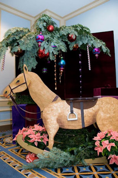 During the cocktail reception, families could have their pictures taken in front of backdrops filled with Christmas decorations and oversize toys.