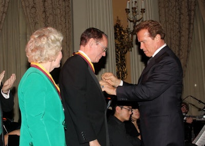 Kathryn and Steven B. Sample received U.S.C. Thornton's John C. Argue Dickens Medals of Honor from California Governor Arnold Schwarzenegger.