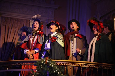 Dressed in period attire, U.S.C. Thornton students serenaded guests with Christmas carols from a balcony in the hotel's ballroom.