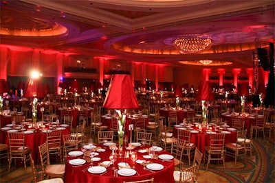 Wow Factor used red and gold lighting, linens, and rental furniture to decorate the ballroom with a feminine feel.