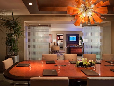 A hospitality suite includes a dining table suitable for in-suite meetings.