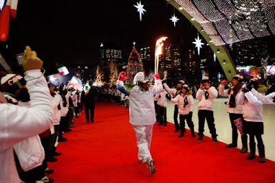 Vicky Sunohara carried the Olympic torch along a red carpet laid out on the ice rink at Nathan Phillips Square.