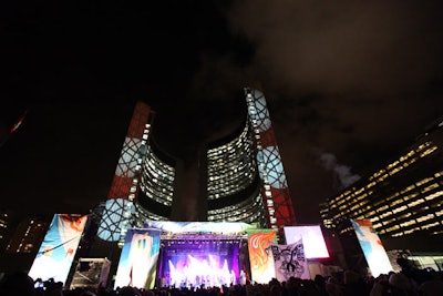 Red and white lighting lit up the city hall towers, and Olympic banners flanked either side of the stage during a ceremony to welcome the Olympic torch to Toronto.