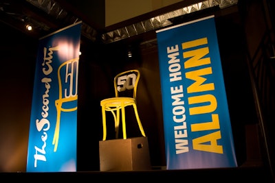 The iconic Second City stage set—a row of chairs against a stark backdrop—inspired the anniversary celebration's logo, which showed up in signage and props.