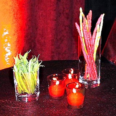 Match Catering put out glasses with green beans and bread sticks on cocktail tables throughout the space.